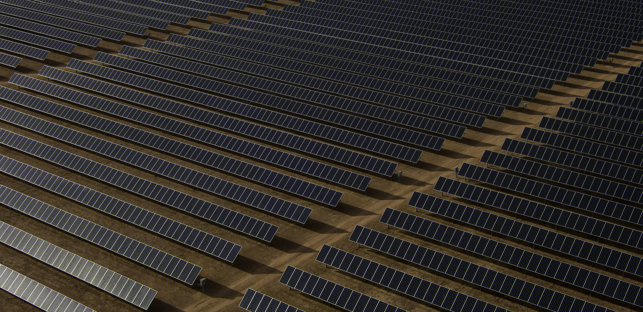 Rows of solar panels under a clear sky